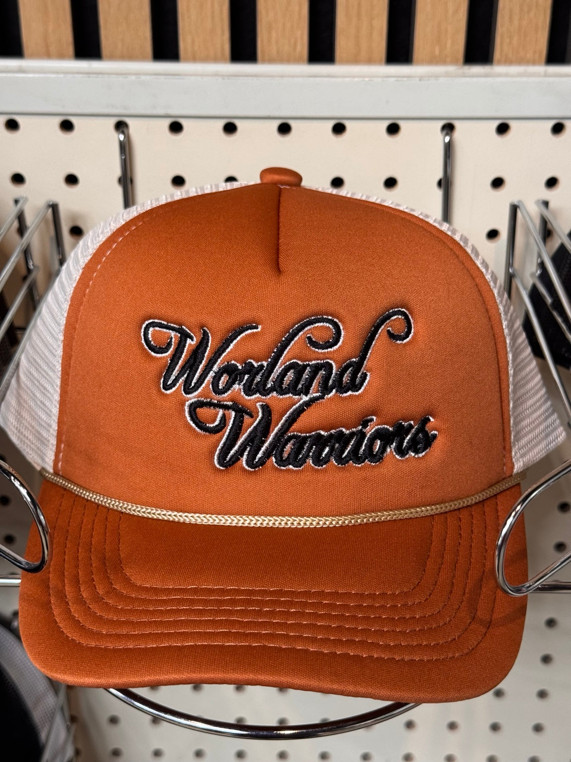 Worland Warriors orange and white script embroidered trucker hat